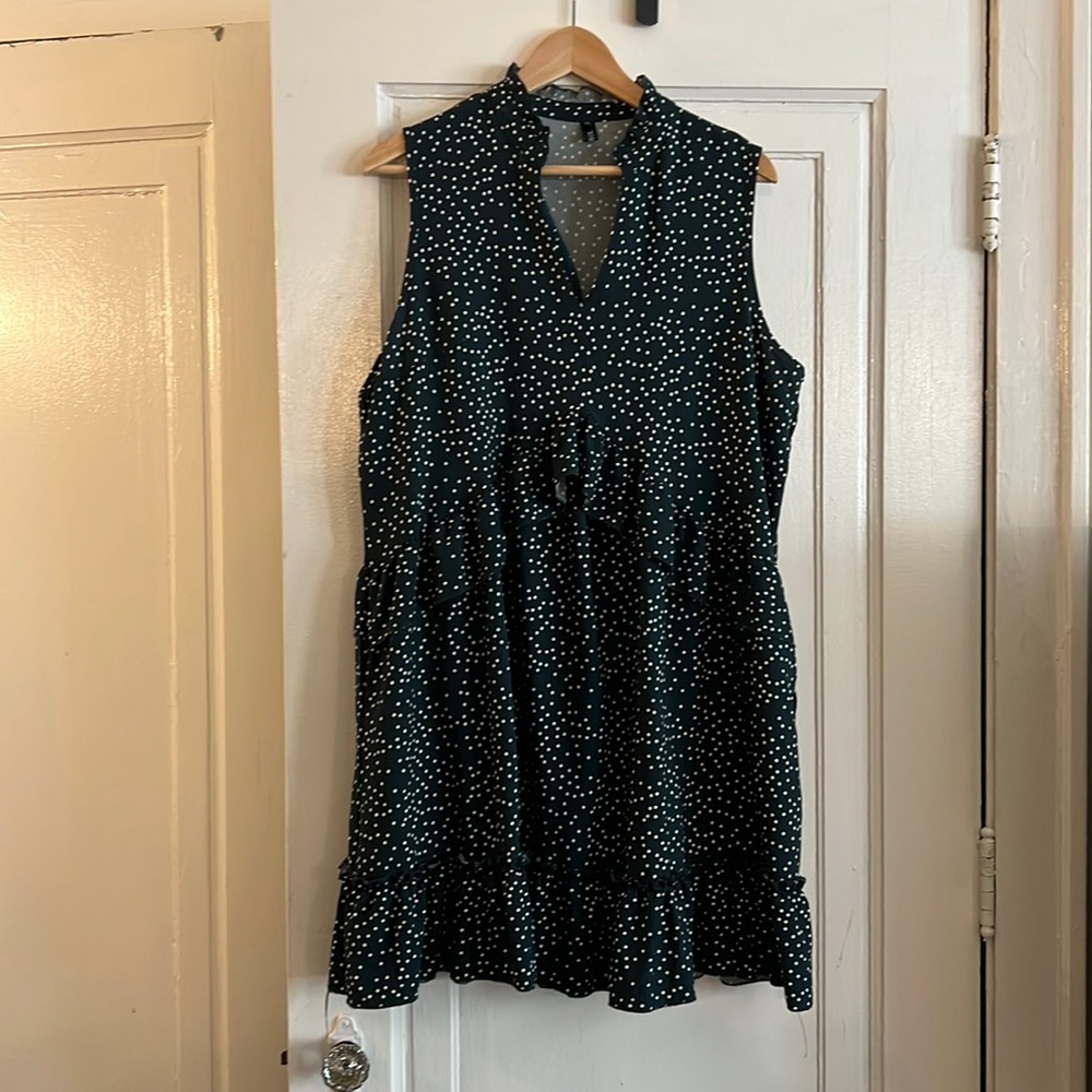 Mirol knee-length green polka-dotted dress.